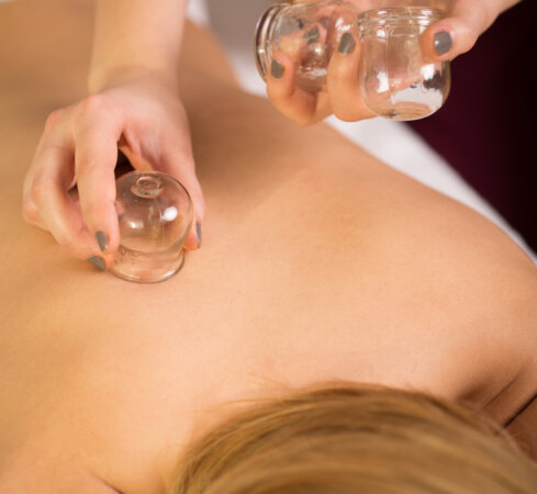 Close-up of woman relaxing during cupping massage